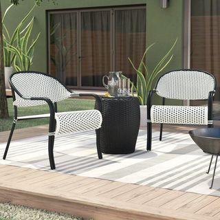 A black and white wicker outdoor conversation set for Kelly Clarkson's furniture collection.
