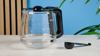 A black Instant Infusion Brew 12-Cup drip coffee maker with a removable water reservoir, glass carafe and reusable coffee filter