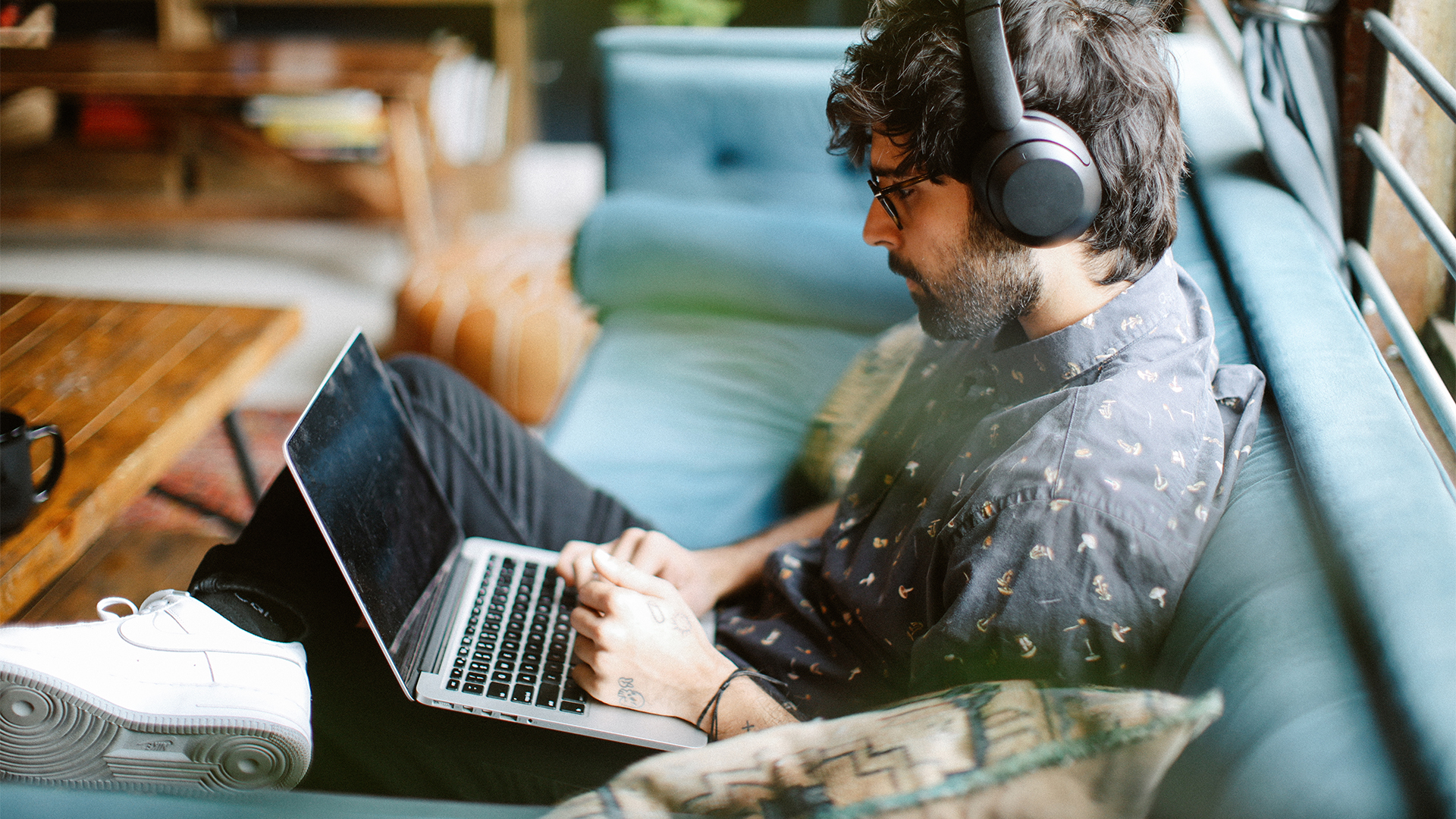 Young man working from home, doing IT work from his home.