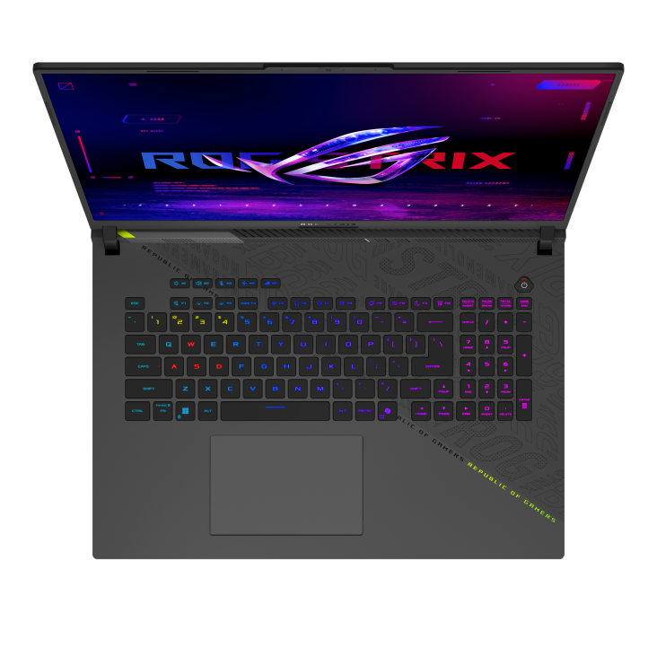 Top-down view of an ASUS ROG Strix gaming laptop with RGB backlit keyboard and colorful screen displaying the ROG logo and Strix branding