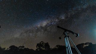A telescope with the night sky in the background