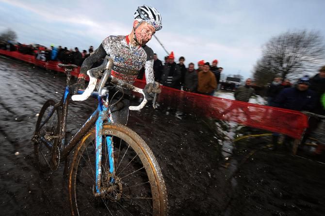 Mathieu van der Poel rusn the mud at Bpost Bank Trofee Azencross.