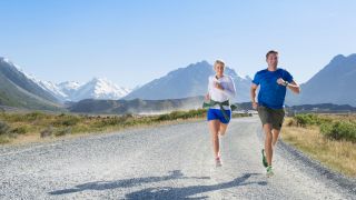couple running on rural road -