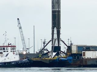 SpaceX's first Falcon 9 booster to fly six times returns home to Port Canaveral in Cape Canaveral, Florida on Aug. 21, 2020 atop the drone ship landing platform Of Course I Still Love You. The rocket launched 58 Starlink satellites and three Planet SkySats from Cape Canaveral Air Force Station on Aug. 18.