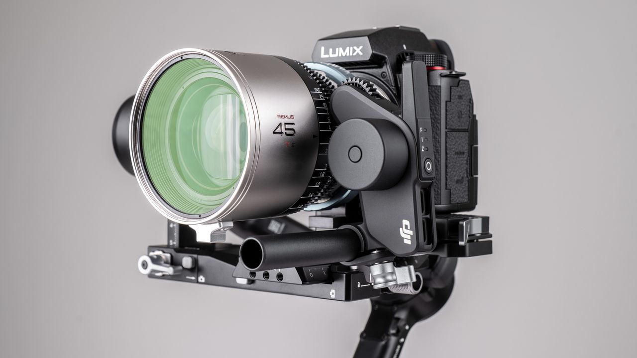 DJI RS 4 gimbal with Focus Pro system connected to cine lens on a off-white background