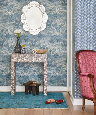 entry with blue toile wallpaper, mother of pearl console and Venetian mirror