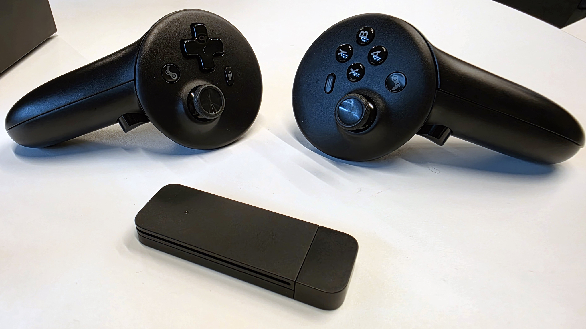 The Steam Frame VR controllers and packed-in wireless dongle