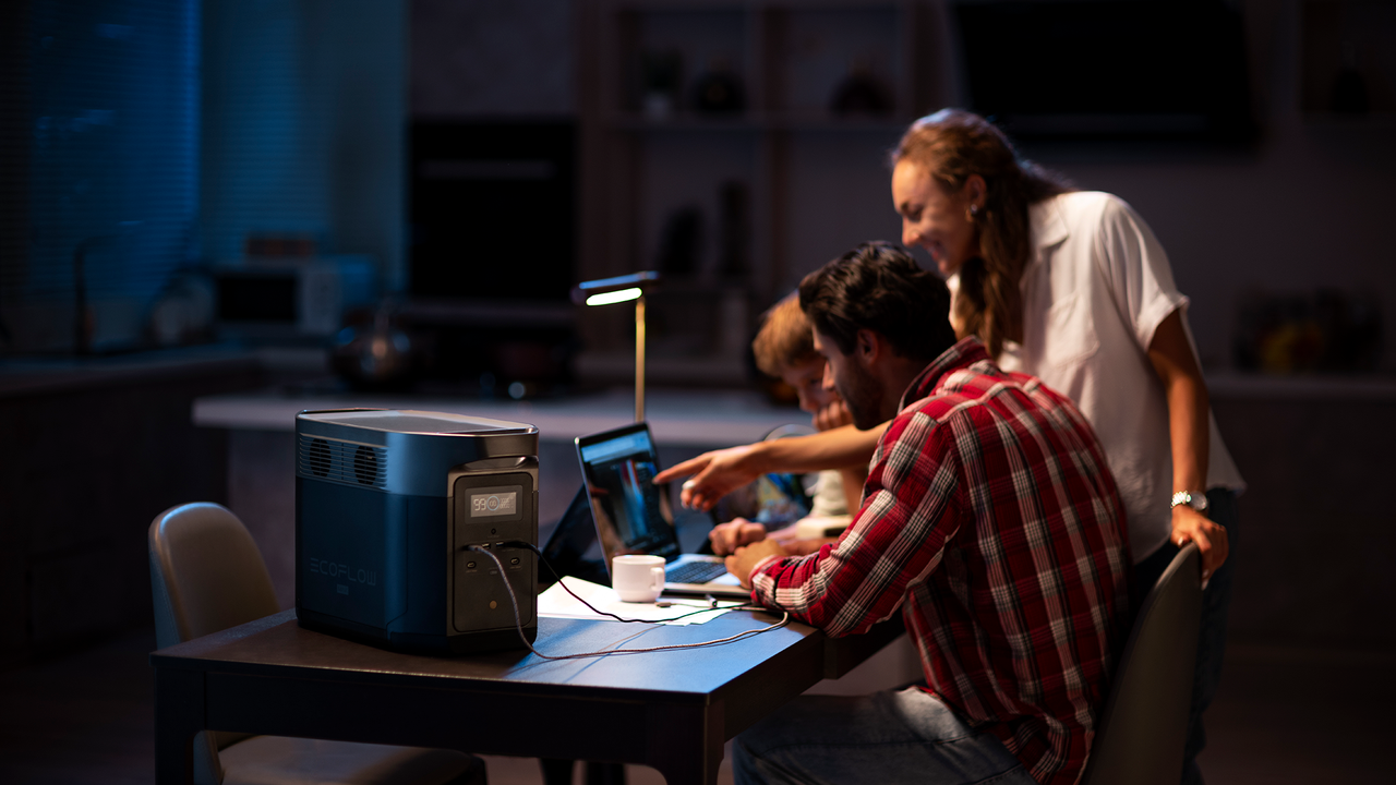 A family gathers using electrical items in a power cut