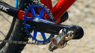 e*thirteen Helix Race crankset fitted to a orange bike with a blue chainring