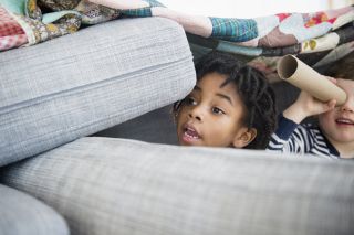 Young boy making pillow fort, one of the things to do with kids