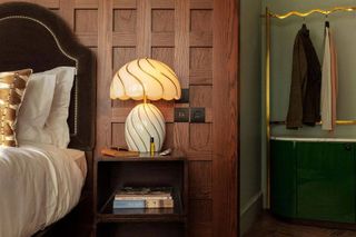 A wood panelled bedroom with luxurious details at The Hoxton Rome