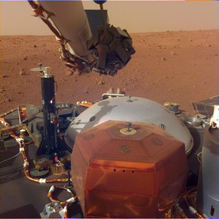 NASA's Mars InSight lander captured this spectacular image on Dec. 4, 2018. It shows the lander's seismometer in the foreground, the cover for that instrument behind it, its self-drilling heat probe to the left and its robotic arm at the top.