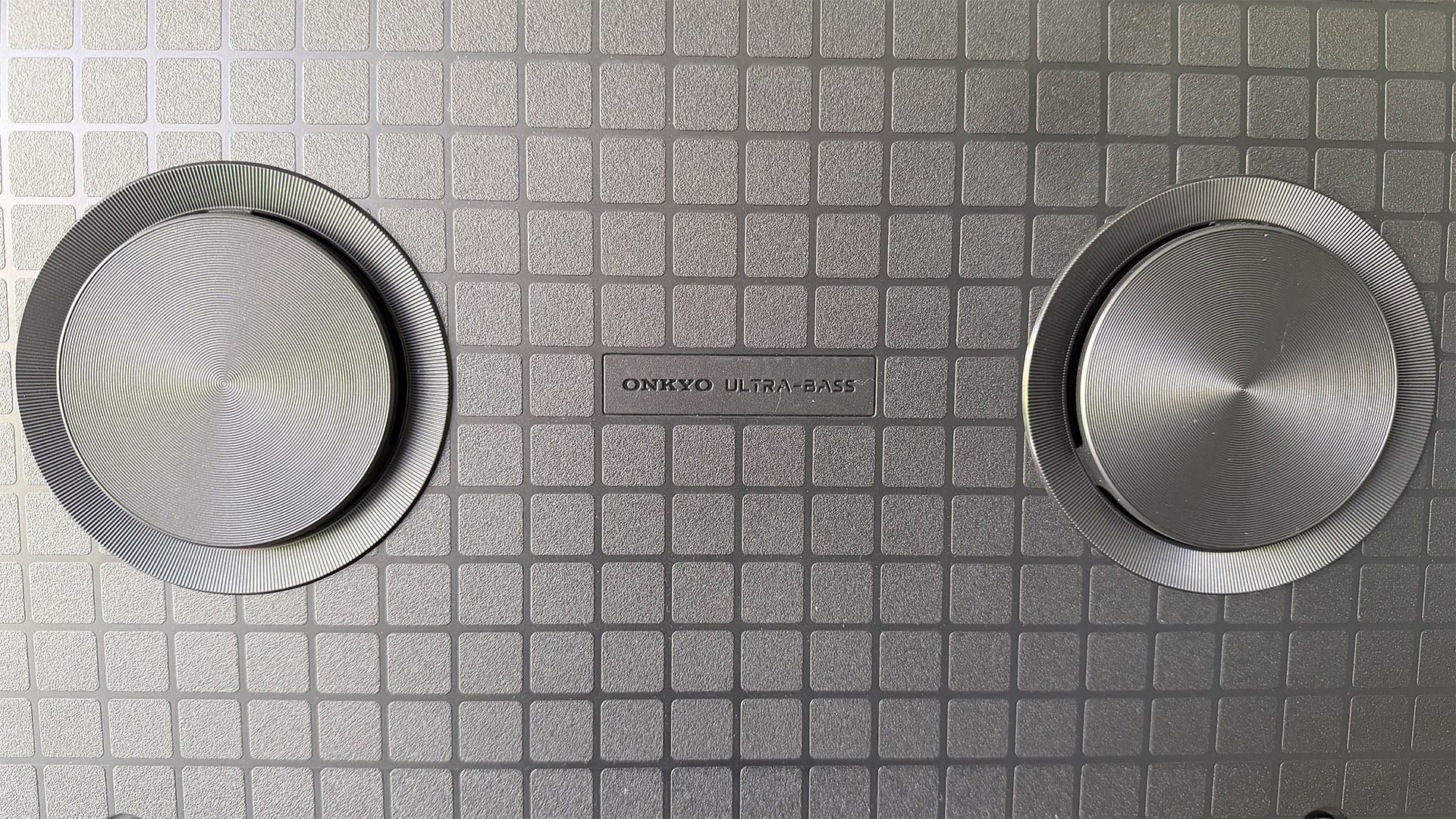 TCL Q6C 65-inch LCD TV, rear of set showing speakers and Onkyo logo