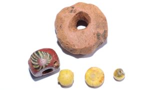 As well as Roman and Middle Eastern coins and pieces of silver, the excavations unearthed many decorative glass beads and a large sandstone bead that were probably used for trading.