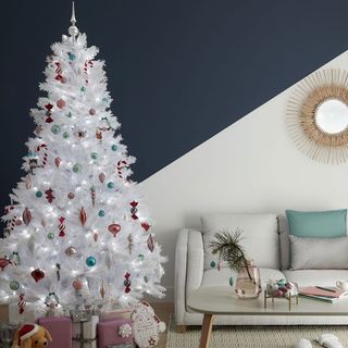 room with christmas tree antique wall mirror and sofa