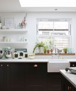 Navy shaker kitchen with white walls and white worktops