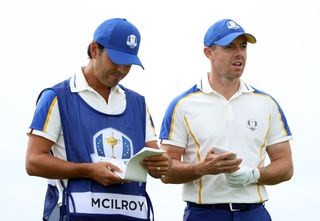 Rory McIlroy talks with his caddie at the 2021 Ryder Cup