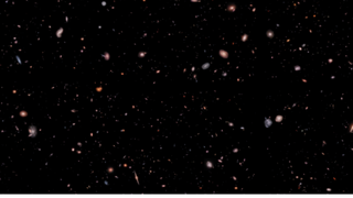hundreds of small, colorful galaxies can be seen in a deep space image