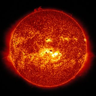 This full-sun view combines two images from NASA's Solar Dynamics Observatory captured on Jan. 7, 2014. Together, the images show the location of a giant sunspot group on the sun, and the position of an X-class flare that erupted at 1:32 p.m. EST.