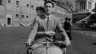 Audrey Hepburn rides a scooter in Roman Holiday