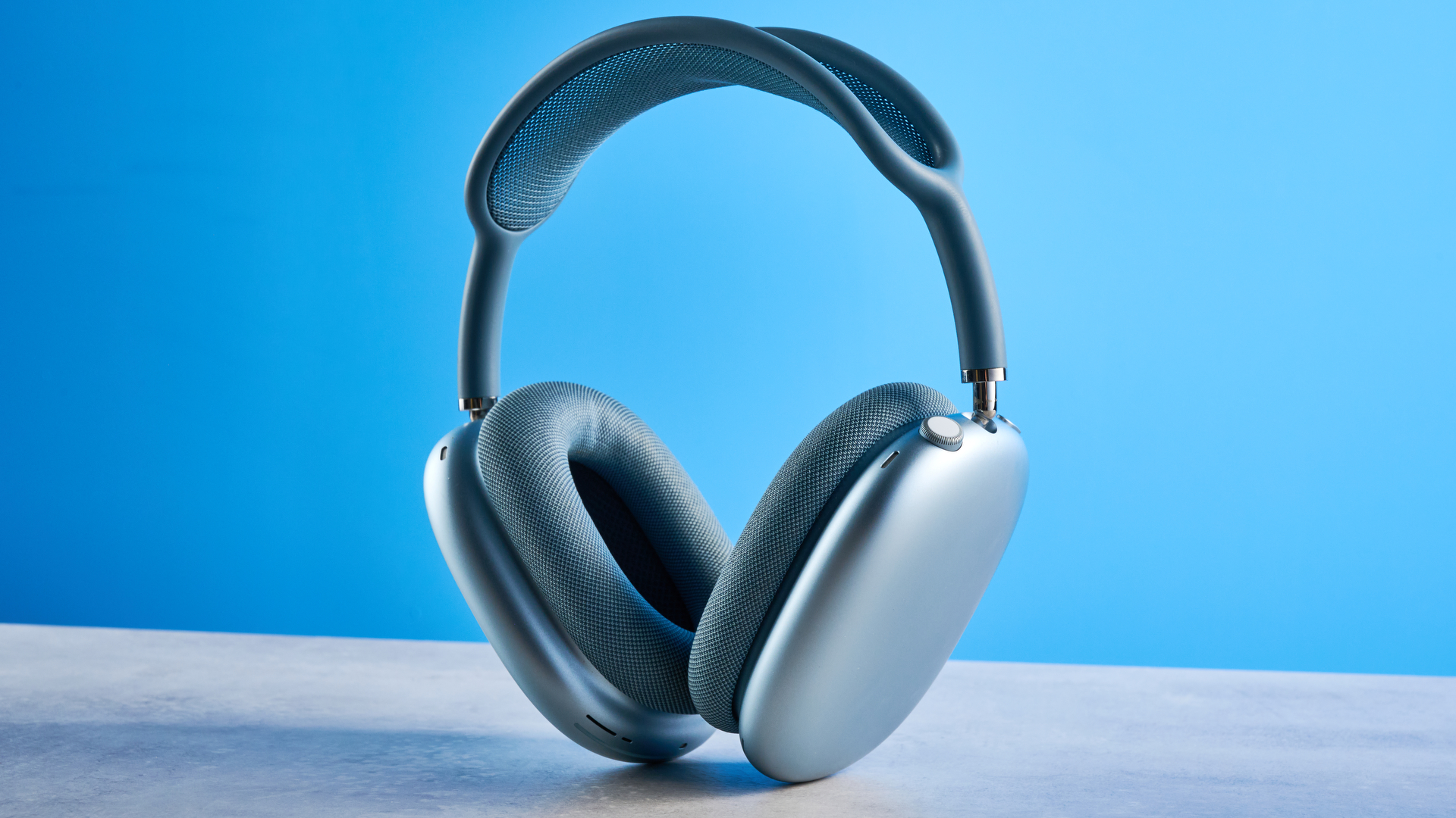 the airpods max (2024 edition) in blue photographed against the blue tom's guide background