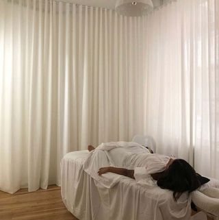 Woman on beauty treatment bed at Gotham Wellness New York salon
