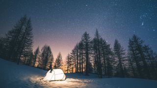 winter camping: tent on a starry winter night