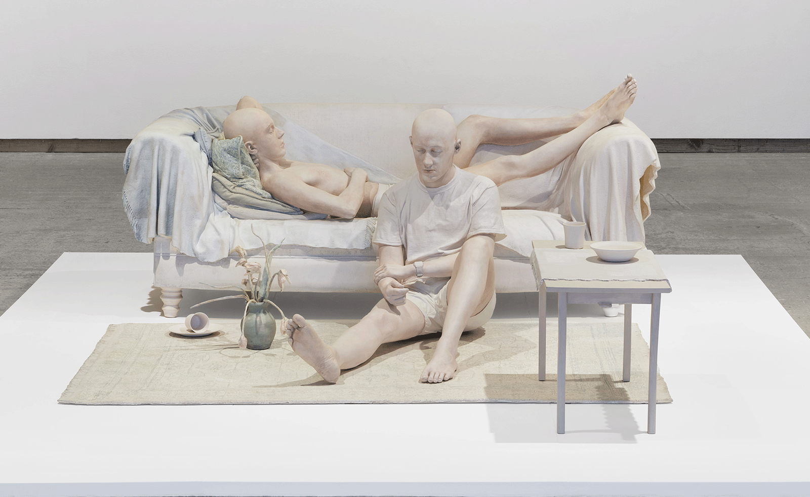 white figures on a sofa