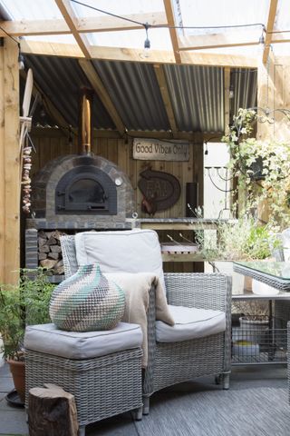 barbeque area with armchair and potted plant
