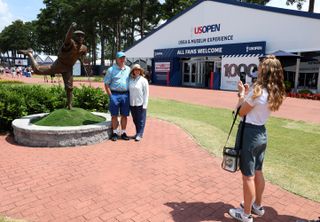 Spectators pose for photographs by the Payne Stewart statue at Pinehurst No 2