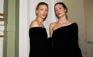 Two fashion model facing front with black dress