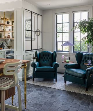 two navy blue armchairs in a kitchen