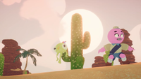 A scene from Peak's Mesa Update. A pink scout character grimaces after getting her plushie caught on a cactus under the glaring sun.