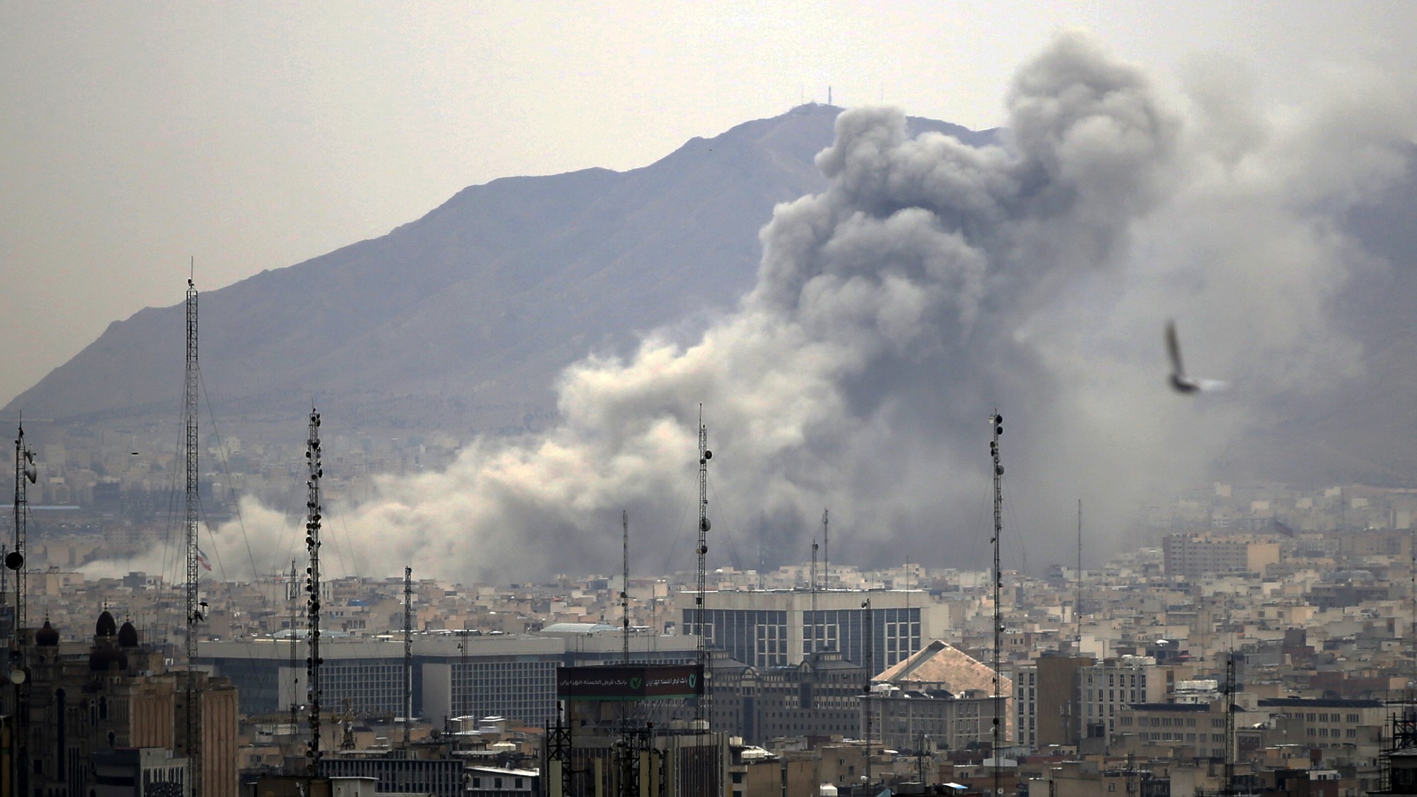 Smoke rises after airstrikes in Tehran