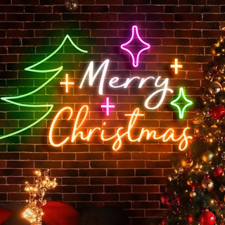 A neon Merry Christmas sign with the outline of a tree and stars surrounding the text