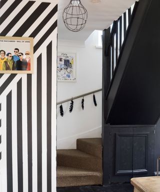 black coloured stairway and striped wall