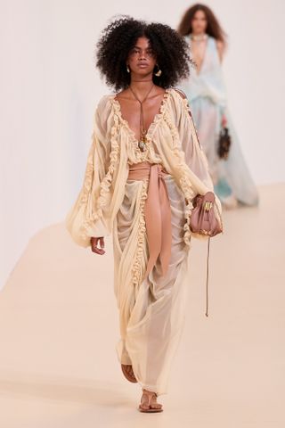 a model at the Zimmermann Spring 25 show in look 006 wearing a ruffled dress with a pink belt