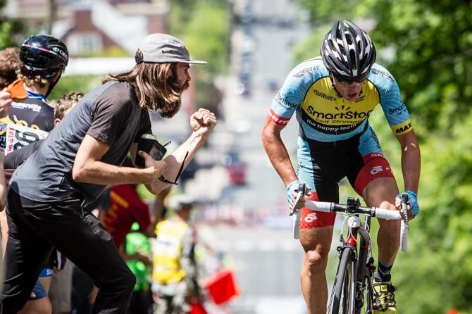 Travis McCabe (SmartStop) is cheered by a fan with one lap to g
