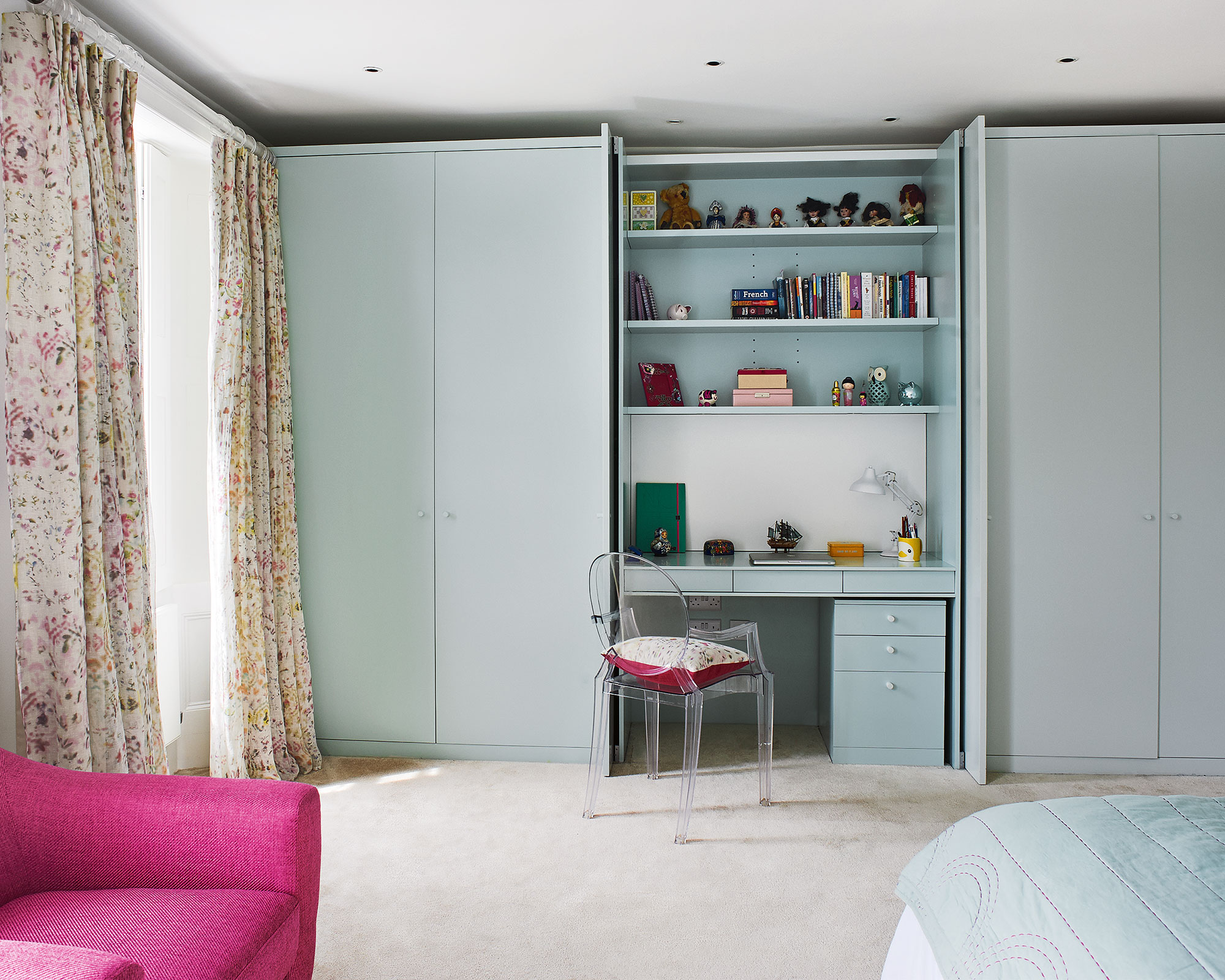 Small bedroom design ideas with multifunctional storage shown by built-in wardrobes, shelving and dressing table.