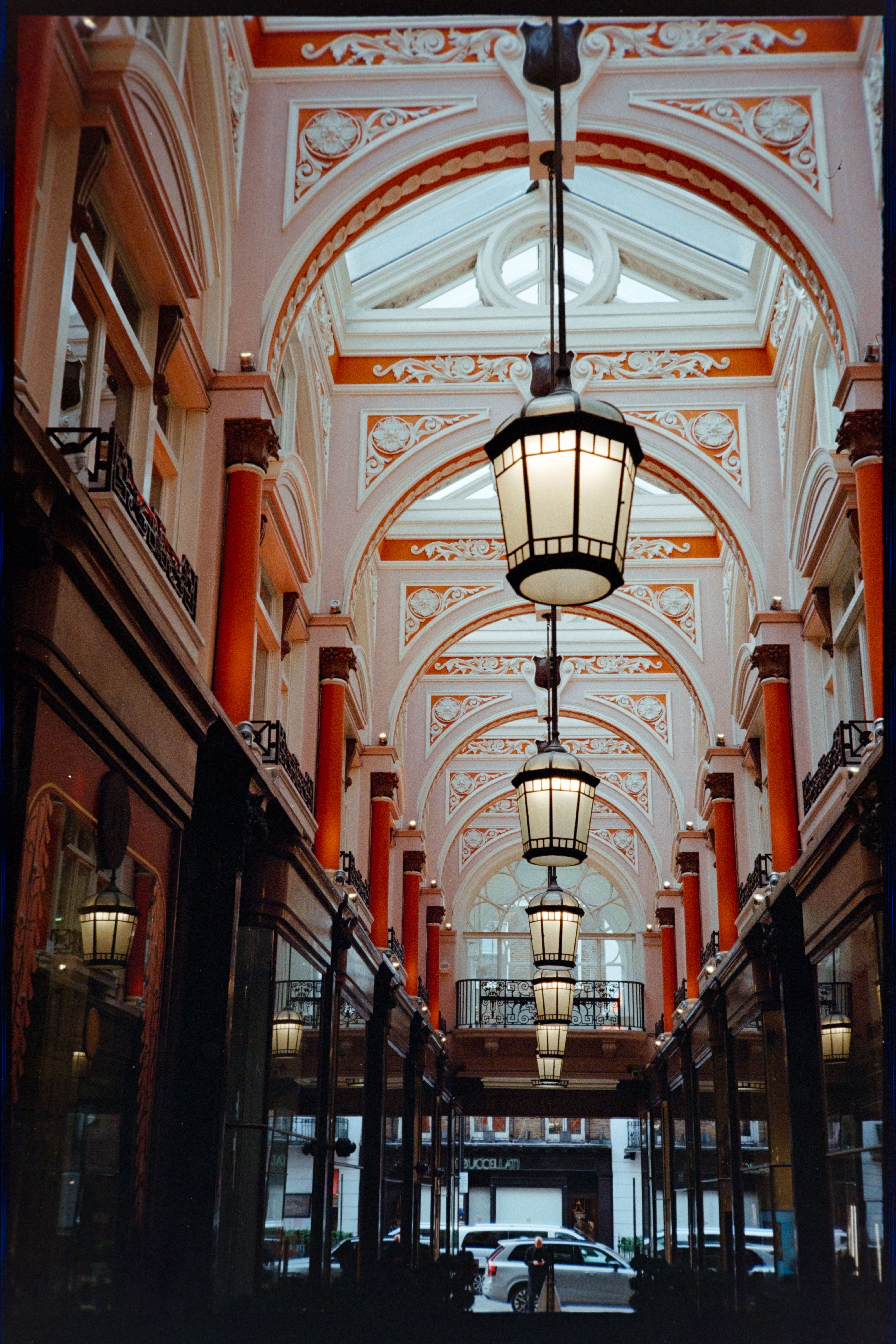An ornate covered shopping arcade with hanging lanterns and a decorative arched ceiling.