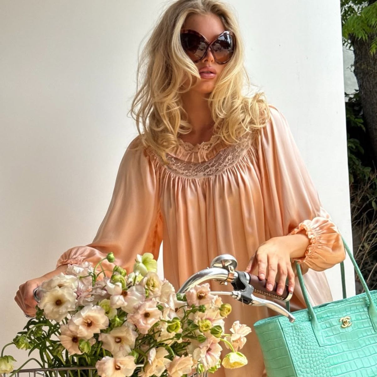 Elsa Hosk with a bike and a bouquet of flowers
