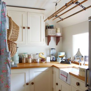 A kitchen with cream cupboards