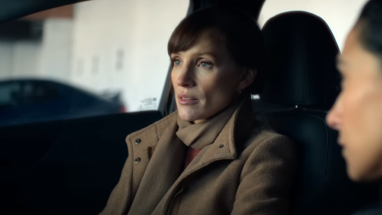 Jessica Chastain looking worried in the passenger seat of a car in The savant