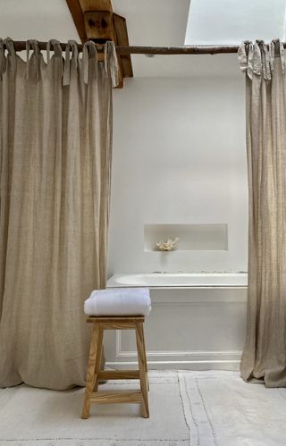 Bath with wooden rail curtains, wooden stool