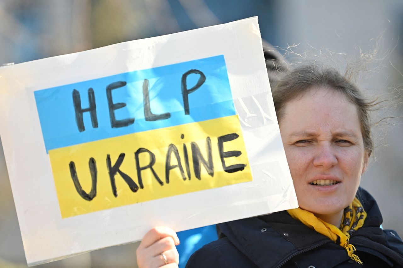 A woman holds a placard during a demonstration called &quot;Women stand with Ukraine&quot; against the Russian invasion of Ukraine as part of International Women&#039;s Day in Brussels, on March 8, 2022, women for Ukraine