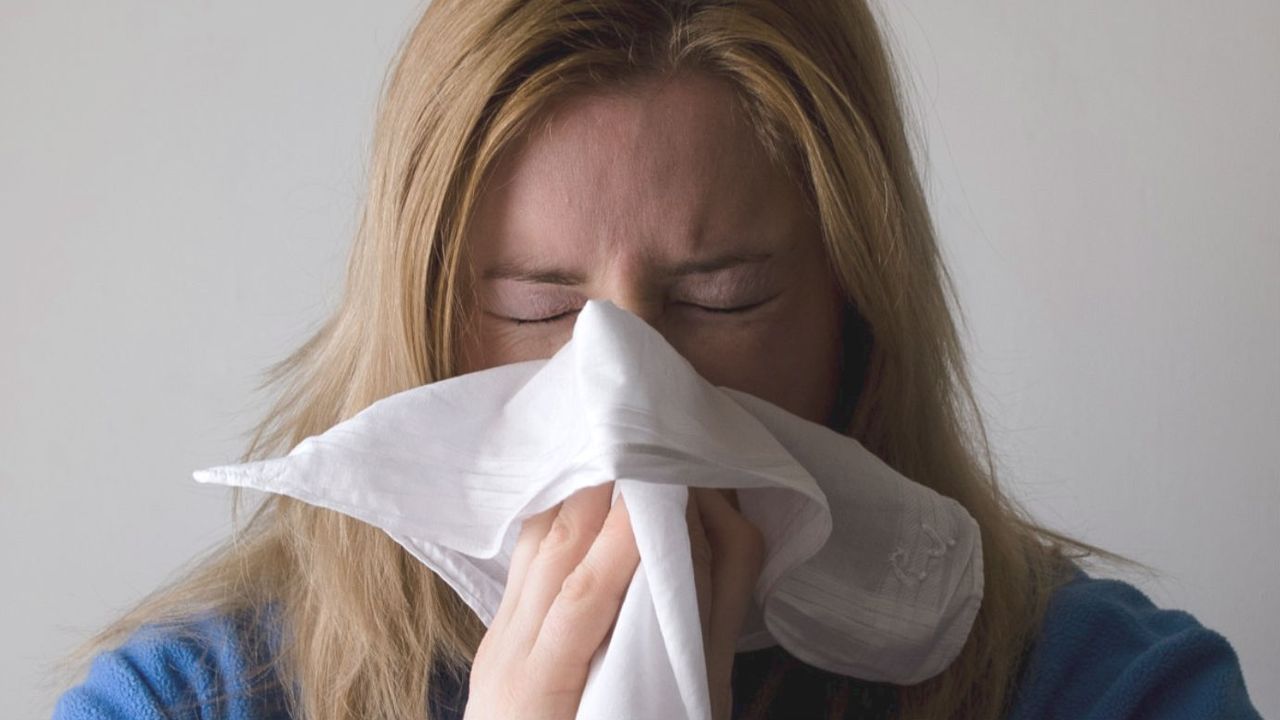 Woman sneezing