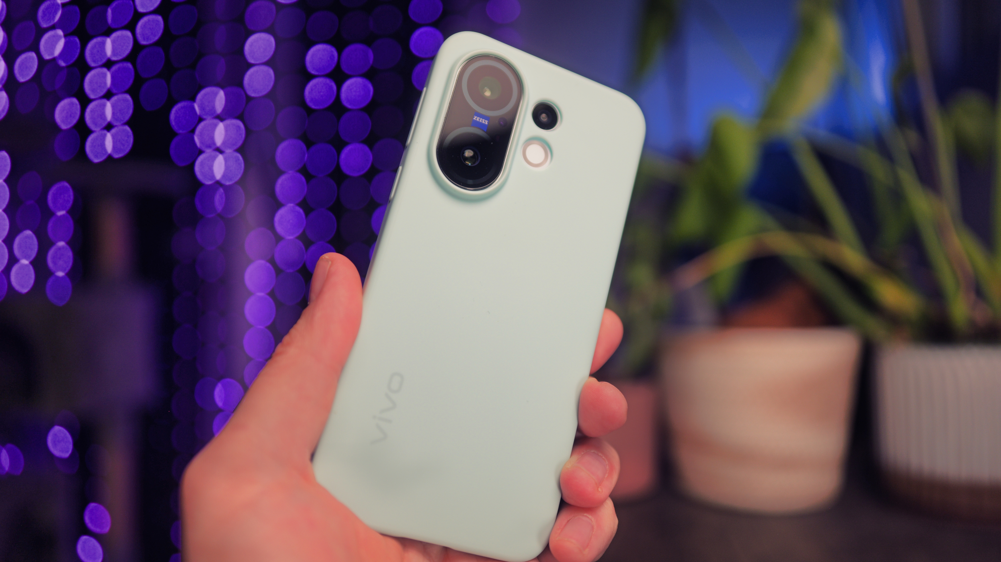 Vivo X200 FE phone in a silicone case held in a hand