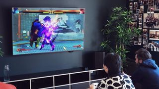 Fighting game beiog played on a big screen TV