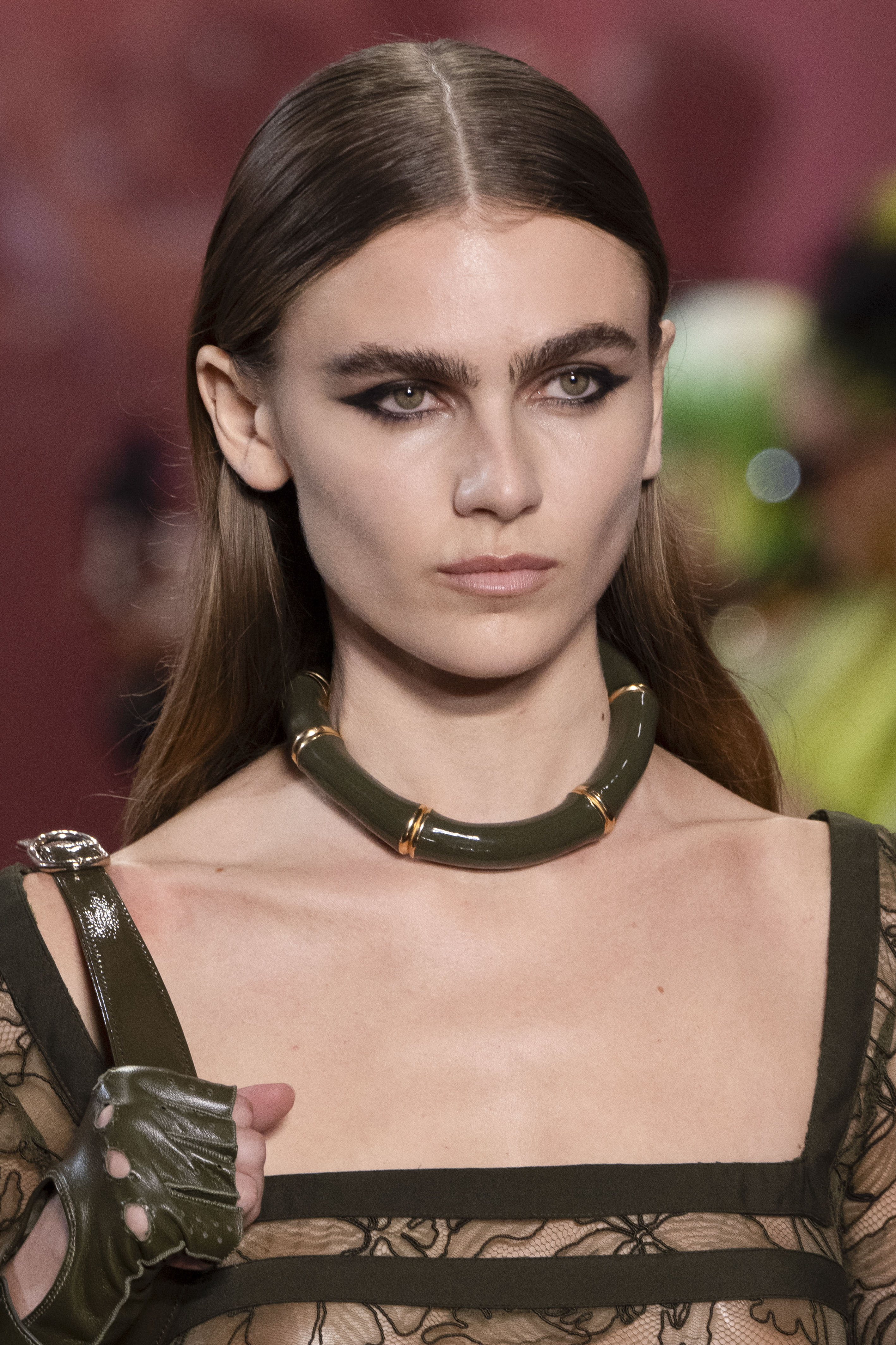 Gucci runway model wearing a green chunky choker necklace.