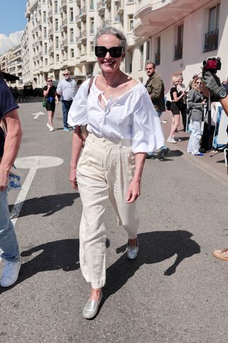 Andie MacDowell walking in Cannes, France, wearing Everlane